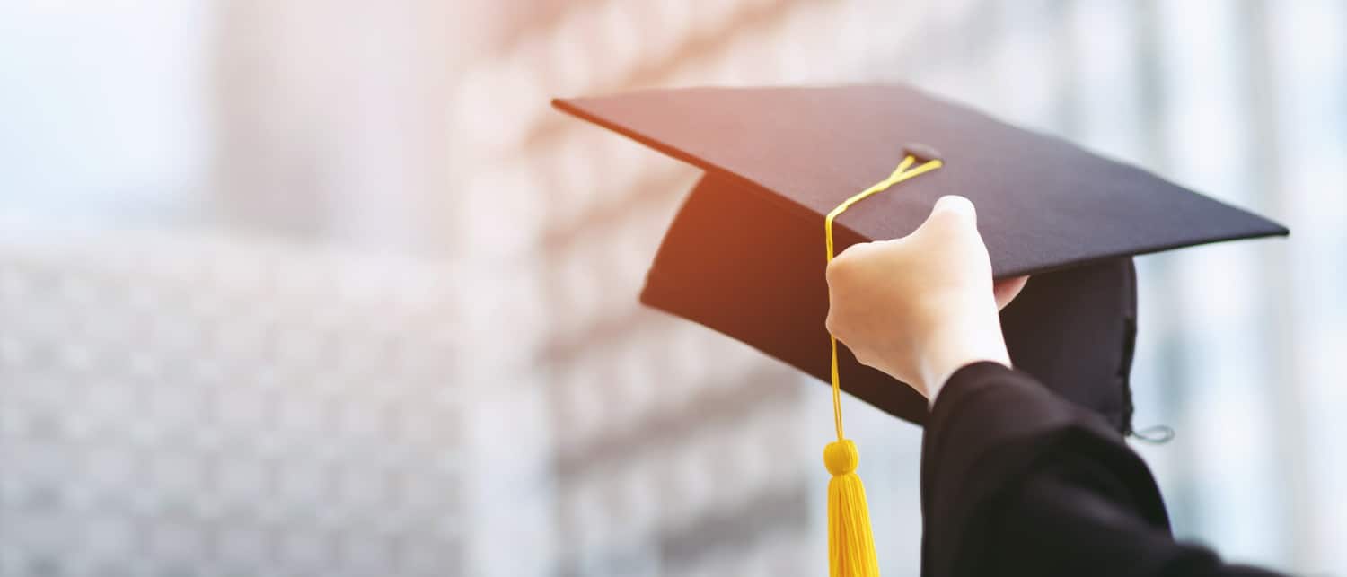 close-up-graduate-hand-hold-show-hat-background-school-building-shot-graduation-cap-during-commencement-university-degree-education-student-success-learning-concept education consultants