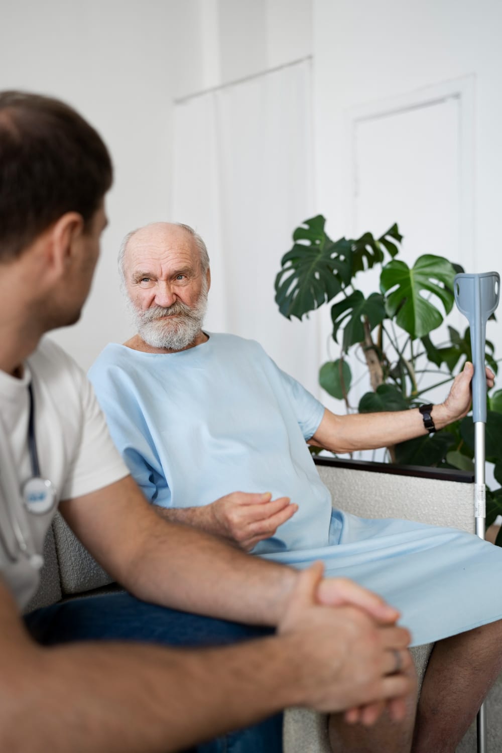 Man in a long term care facility with a member of staff man in a long term care facility with a member of staff