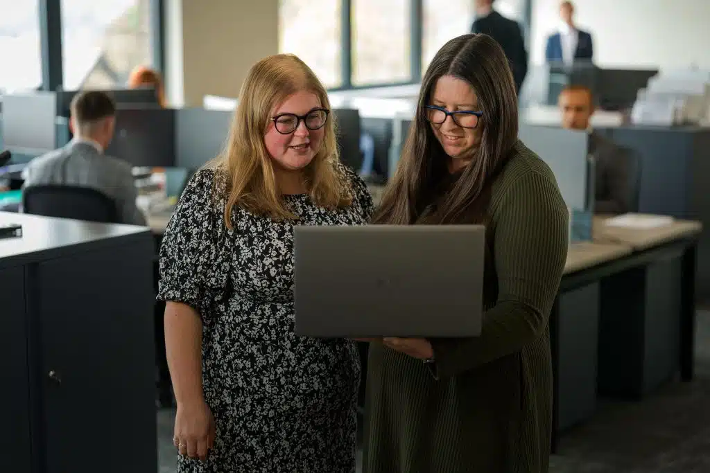 Charlotte Owen and Claire Pass working on a laptop